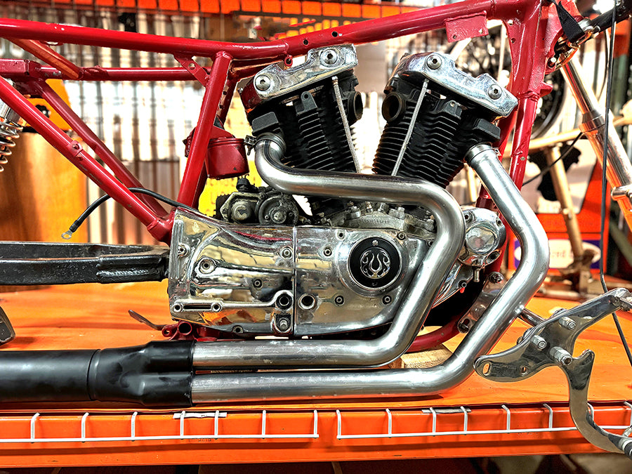 V-Twin Alphabet XL exhaust header set, raw finish, shown as a complete exhaust system component.